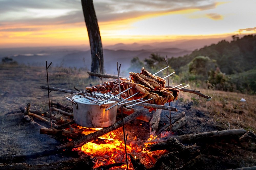 pots and pans on a campfire